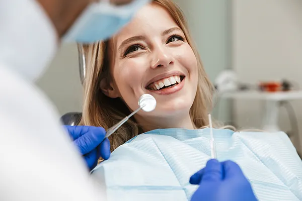 Relaxed patient waiting in a dental chair for her dentist to begin her routine dental exam.